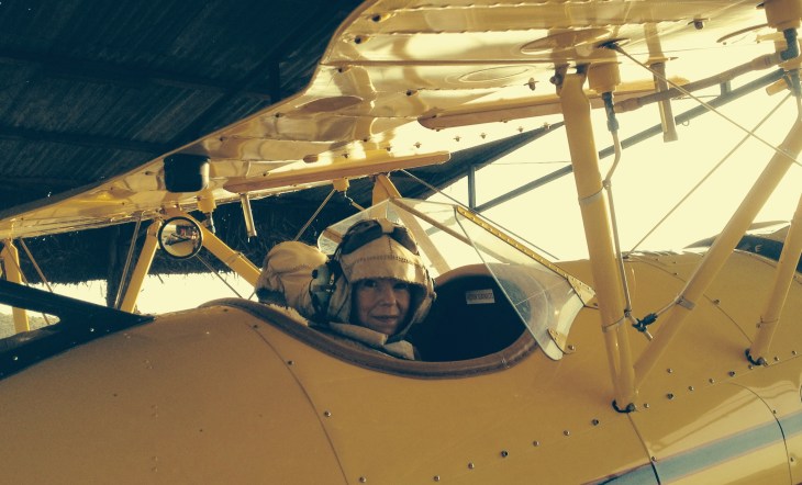 Paula McLain gets into Beryl Markham's frame of mind (and into a bi-plane -- the Gypsy Moth, which was used in the filming of Out of Africa). Photo by Liz Wheeler.